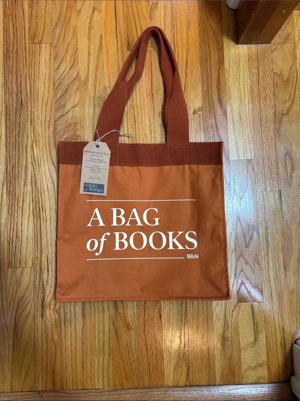 Barnes & Noble Rust Orange Canvas Messenger Tote with White Text